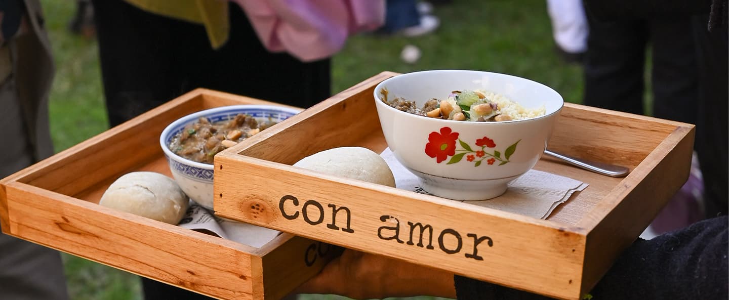 Tabla de madera con guiso y pan casero, servida con cariño